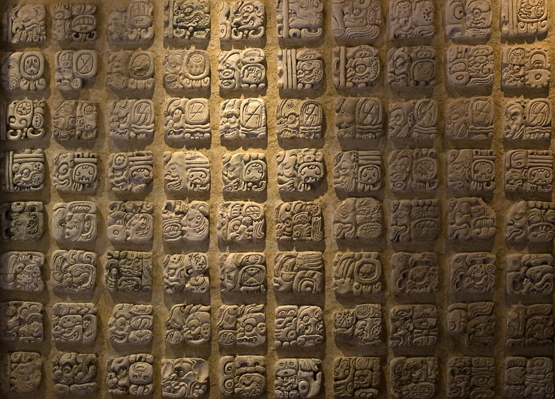 carved mayan stone lettering stones in a wall